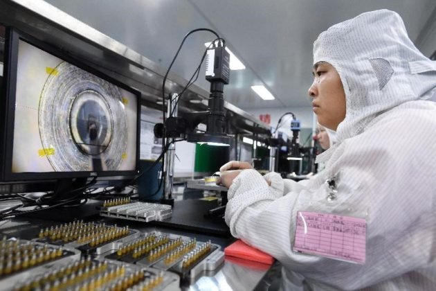 A worker with Jiangxi TFC Technology Co., Ltd. located in Gao’an city, east China’s Jiangxi province, tests precision components for optical network connection. The company’s optical waveguide products enjoy a global market share of more than 30 percent. (People’s Daily Online/ Zhou Liang)