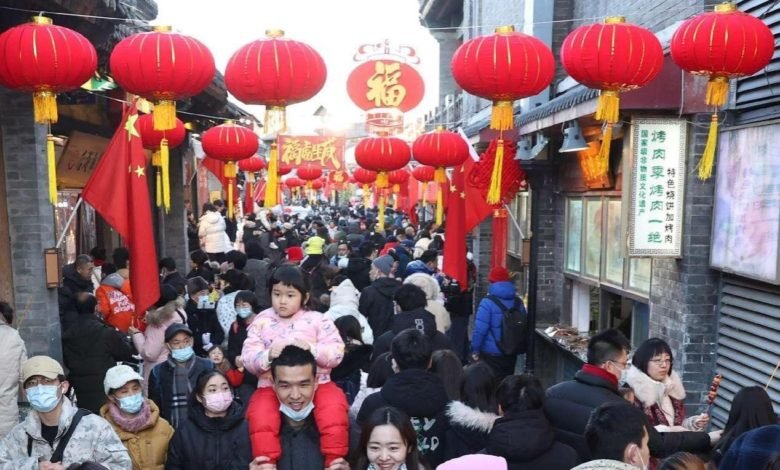 People visit Yandaixie Street, which literally means "Skewed Tobacco Pouch Street", in Beijing, Feb. 1, 2022. (Photo by Chen Xiaogen/People's Daily Online)