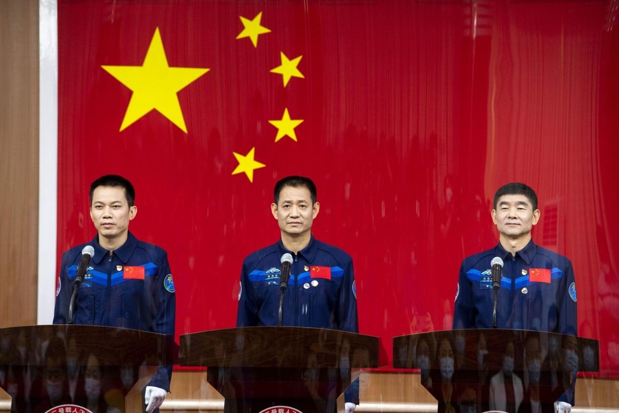 Chinese astronauts Nie Haisheng (C), Liu Boming (R) and Tang Hongbo for the Shenzhou-12 mission meet the press at the Jiuquan Satellite Launch Center in northwest China, June 16, 2021. (Photo by Weng Qiyu/People’s Daily Online)